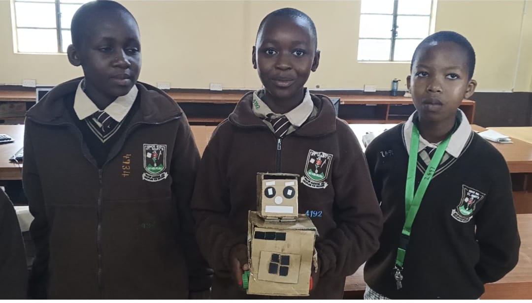 A student building a structure during a hands-on project.